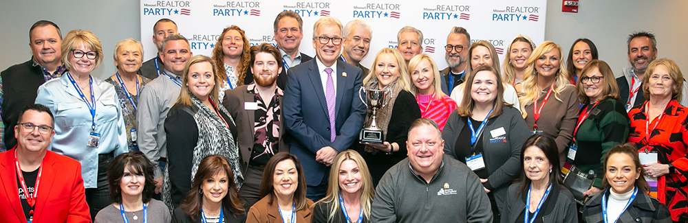 Members posing with an RPAC award as a group.