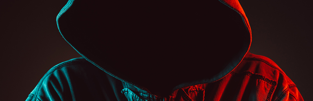 Realtor Safety Red and blue lit low key portrait of hooded person
