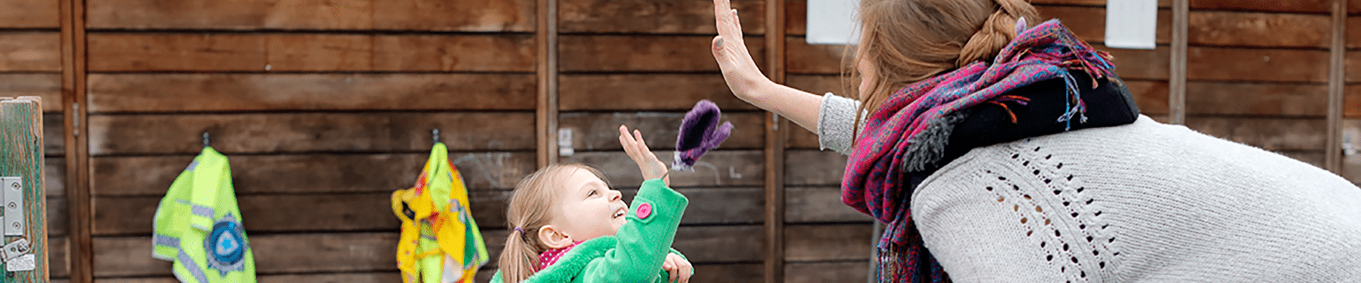 Young girl high-fiving a young woman