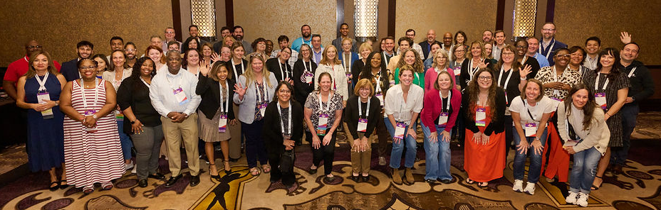 A group shot of about 100 people standing