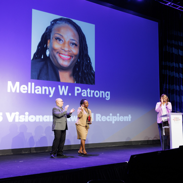 Honors Committee Member Juan Azcarate (left) presents award to 2025 Visionary Award Recipient Mellany Patrong