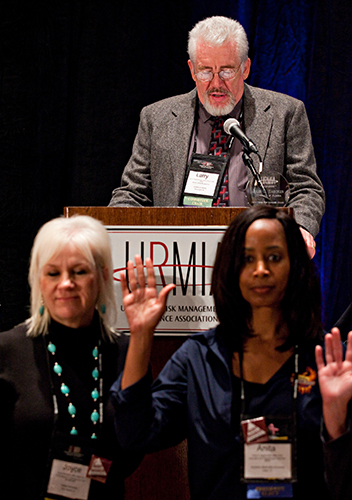 Larry Stephens speaks at podium while board members are being sworn in