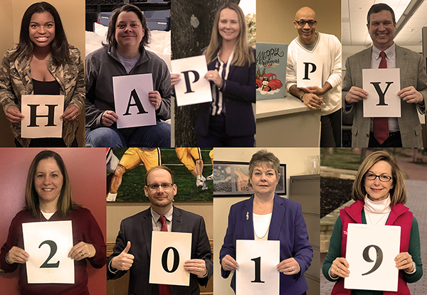 URMIA Board of Director members holding pieces of paper that spell out "Happy 2019"