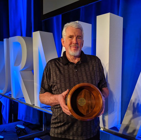 Larry V. Stephens holding Lifetime Achievement Award