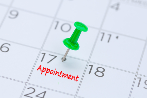 Pin on calendar marking appointment Calendar with a push pin marking an appointment