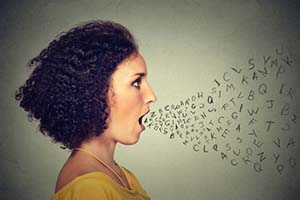 Surreal photo of girl yelling and letters coming out of her mouth