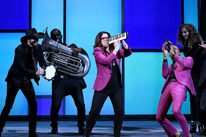 Jo Ann Ross, Jon Batiste, and Stay Human from The Late Show with Stephen Colbert preforming on stage with instruments