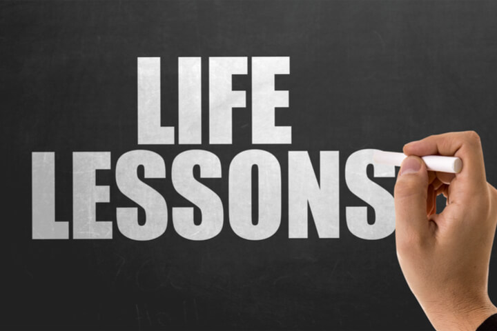 Someone writing "life lessons" on a chalkboard