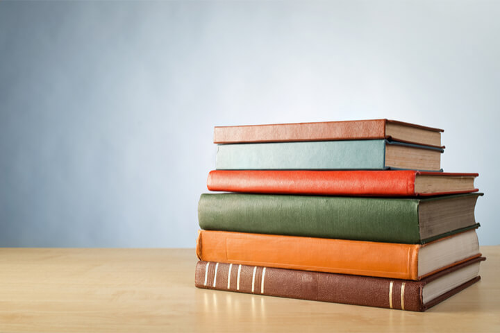 Stack of different sized books on a table