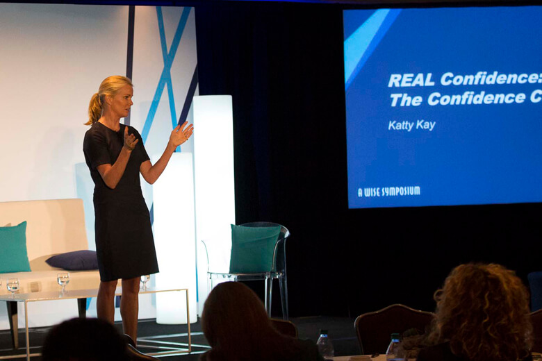 A women giving a presentation to a small audience