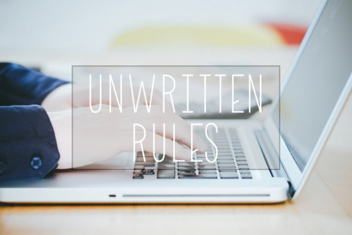 "Unwritten Rules" with the background of a person typing on a laptop