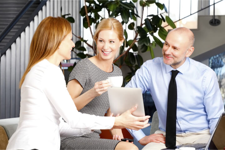 An Agent showing a couple information on a tablet