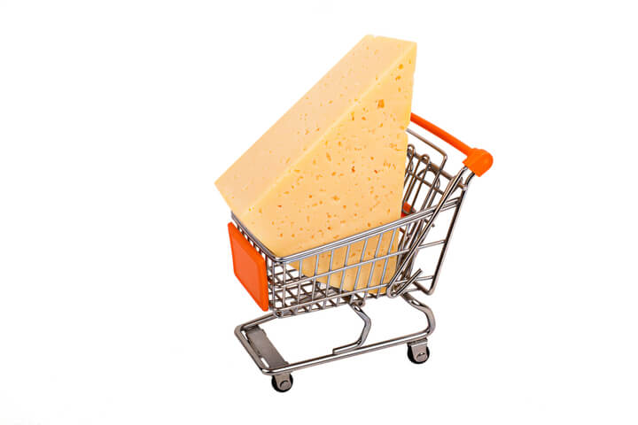 A block of cheese in a grocery cart