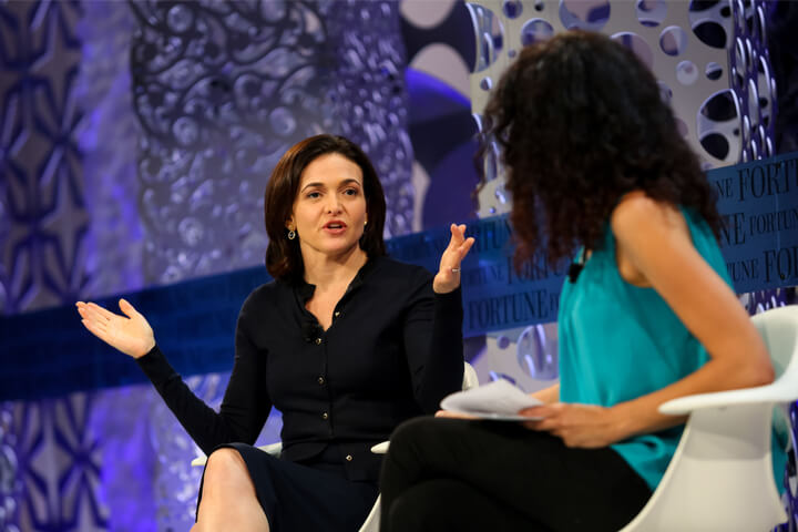 Two women on a stage giving a presentation