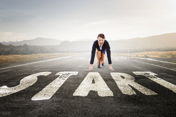 A woman in the ready position for before starting a race