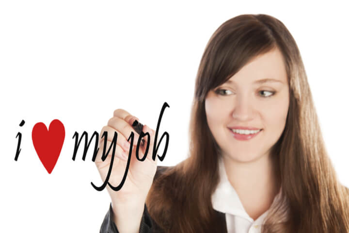 A woman writing "I heart my job"