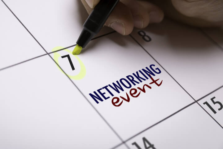 A person circling the number 7 on a calendar, that also says "networking event"