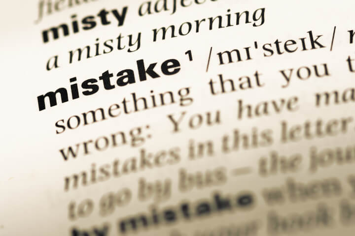 Close up to a page in a dictionary, with the word "Mistake" bolded