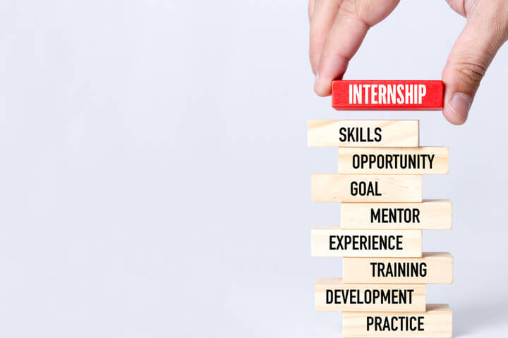 A person putting the chip "Internship" on top of a bunch of chips referring to skills needed for internship