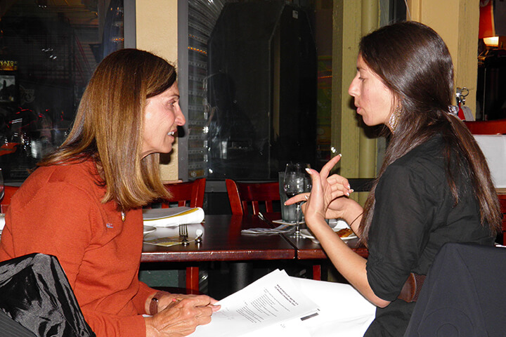 Paulette Goodrich discussing with her mentee while out for a nice dinner