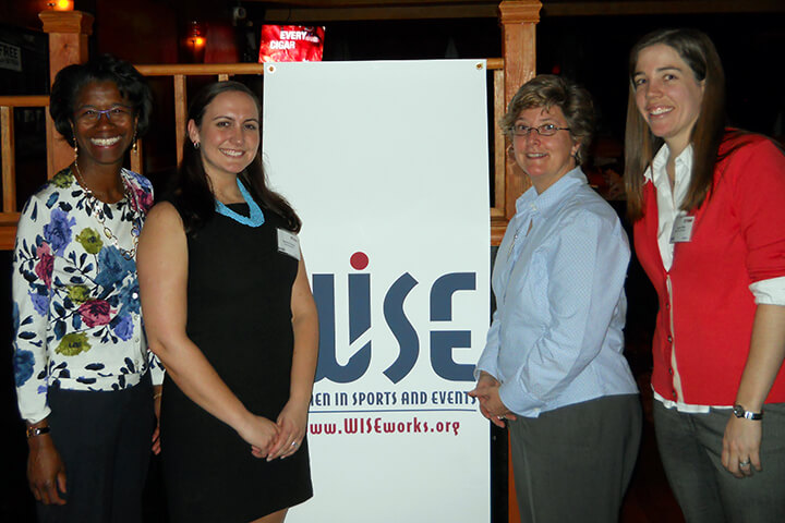 Group Photo with mentors and mentees in front of a WISE Within Event Banner